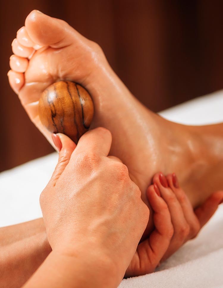 reflexology foot massage with wooden massage too 2026 01 05 22 53 12 utc